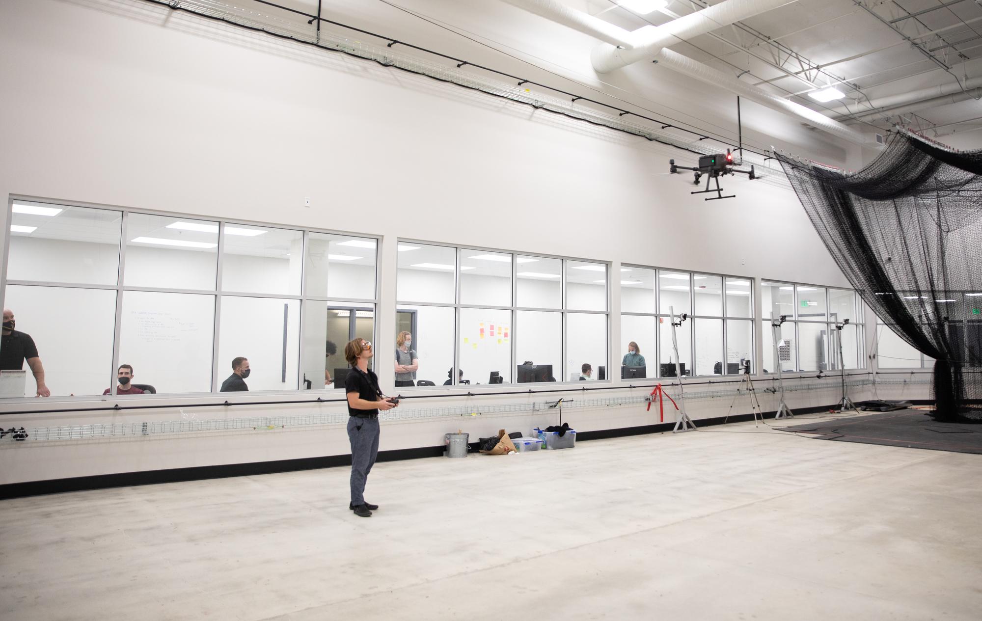 Student at  the Westside Research Park in a drone testing studio. 
